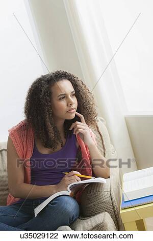 Stock Image - Girl (12-13) studying. Fotosearch