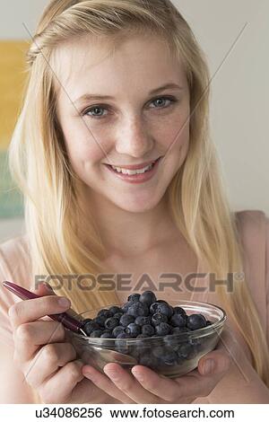 Girl (14-15) holding bowl of black berries View Large Photo Image Stock Photograph - Girl (14-15) holding bowl of black berries. Fotosearch