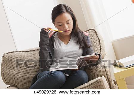 Girl (16-17) studying View Large Photo Image Stock Photograph - Girl (16-17) studying. Fotosearch
