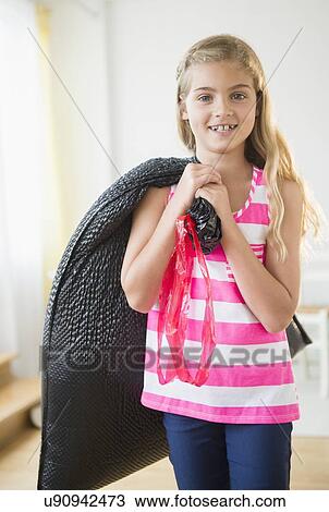 Girl (8-9) carrying bag with trash View Large Photo Image Stock Image - Girl (8-9) carrying bag with trash. Fotosearch
