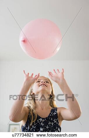 Girl (8-9) playing with pink balloon View Large Photo Image Stock Image - Girl (8-9) playing with pink balloon. Fotosearch