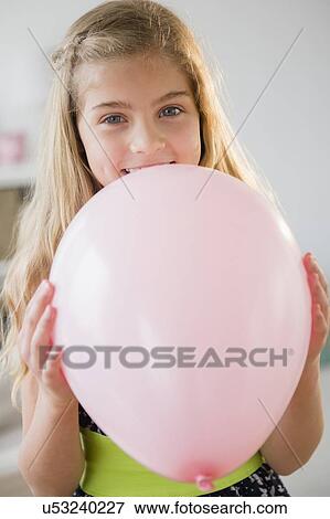 Girl (8-9) with pink balloon View Large Photo Image Stock Photo - Girl (8-9) with pink balloon. Fotosearch