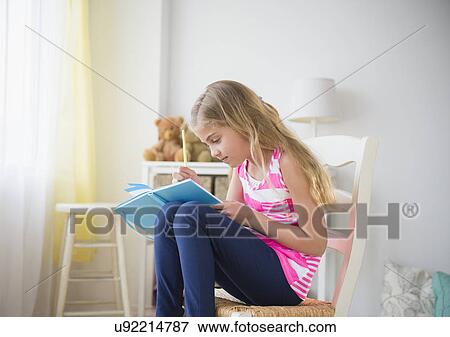 Girl (8-9) writing diary View Large Photo Image Stock Photo - Girl (8-9) writing diary. Fotosearch