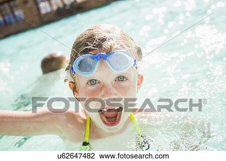 Girl and boy (4-5) playing in swimming pool View Large Photo Image Stock Image - Girl and boy (4-5) playing in swimming pool. Fotosearch