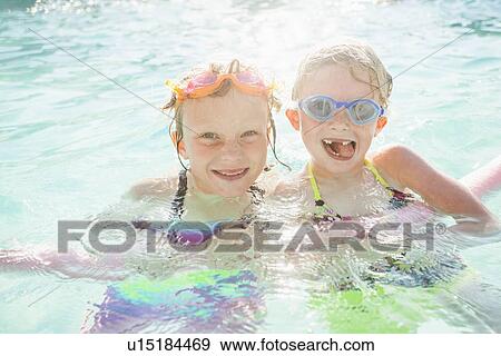 Stock Photo - Girlfriends (4-5, 8-9) playing in swimming pool. Fotosearch