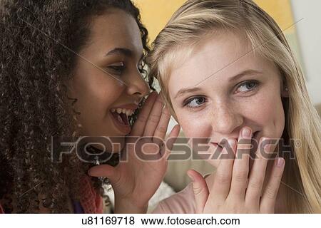 Stock Photo - Girls (14-15, 12-13) gossiping. Fotosearch