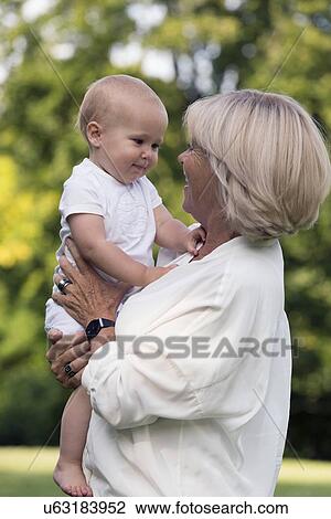 Grandma and her granddaughter (-12-17 months) in park View Large Photo Image Stock Image - Grandma and her granddaughter (-12-17 months) in park. Fotosearch