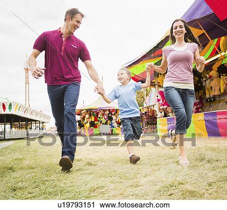 Happy Family and son (4-5) in amusement park View Large Photo Image Stock Image - Happy Family and son (4-5) in amusement park. Fotosearch