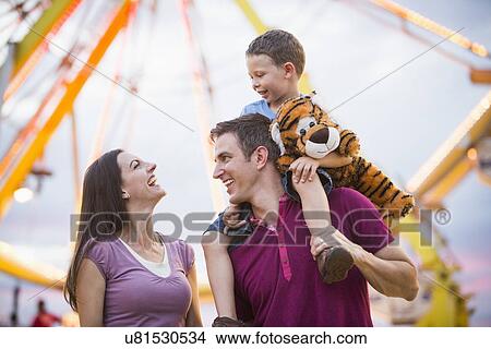 Happy Family with son (4-5) in amusement park View Large Photo Image Picture - Happy Family with son (4-5) in amusement park. Fotosearch