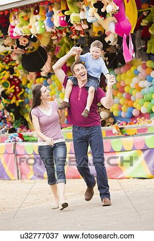 Happy Family with son (4-5) in amusement park View Large Photo Image Stock Photo - Happy Family with son (4-5) in amusement park. Fotosearch