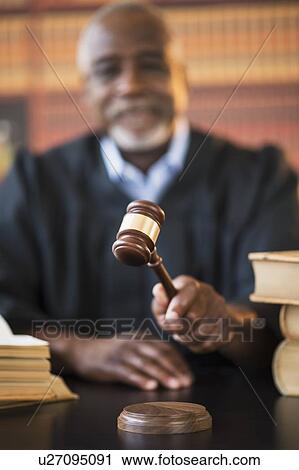 Judge holding gavel in courtroom View Large Photo Image Stock Image - Judge holding gavel in courtroom. Fotosearch
