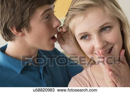 Stock Image - Kids (14-15) gossiping. Fotosearch
