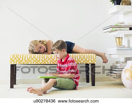 Kids (4-5, 6-7) using digital tablet indoors View Large Photo Image Stock Photograph - Kids (4-5, 6-7) using digital tablet indoors. Fotosearch