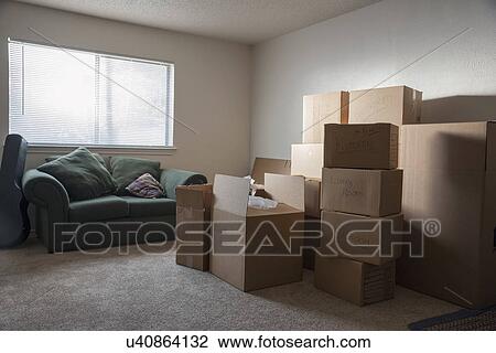 Stock Image - Living room filled with cardboard boxes. Fotosearch