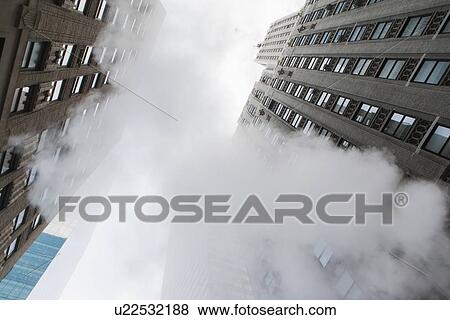 Low angle view of skyscraper and steam View Large Photo Image Stock Photo - Low angle view of skyscraper and steam. Fotosearch