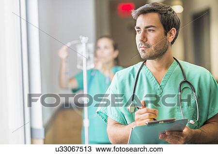 Male doctor in hospital hallway View Large Photo Image Stock Image - Male doctor in hospital hallway. Fotosearch