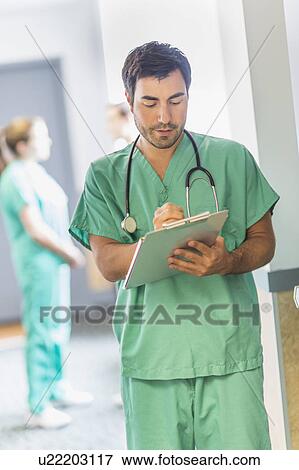Stock Photo - Male doctor in hospital hallway. Fotosearch