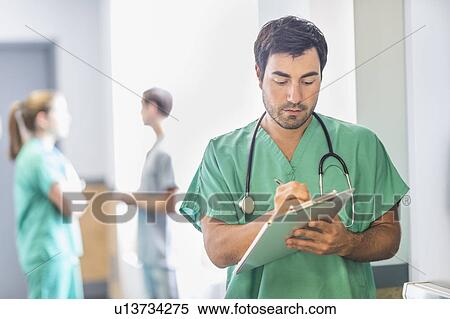 Stock Photography - Male doctor in hospital hallway. Fotosearch