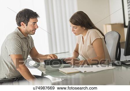 Man and woman talking in office View Large Photo Image Stock Photo - Man and woman talking in office. Fotosearch