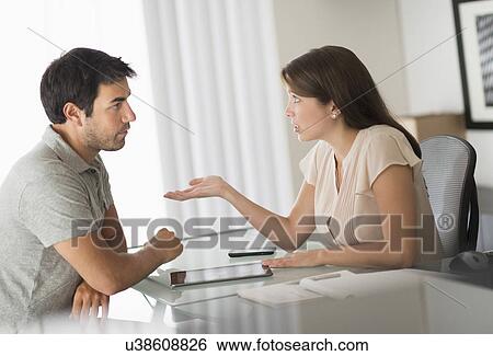 Man and woman talking in office View Large Photo Image Stock Photograph - Man and woman talking in office. Fotosearch