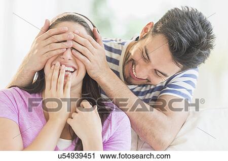 Man covering woman's eyes with his hands View Large Photo Image Stock Image - Man covering woman's eyes with his hands. Fotosearch