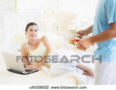 Man serving breakfast to woman in bed View Large Photo Image Stock Image - Man serving breakfast to woman in bed. Fotosearch