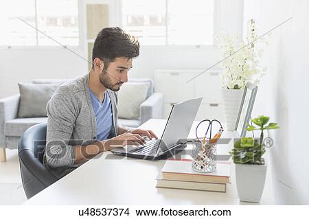 Man using laptop at home View Large Photo Image Picture - Man using laptop at home. Fotosearch