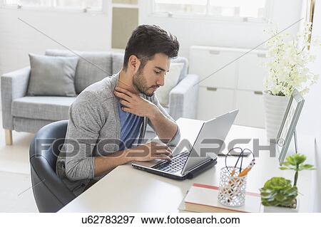 Man using laptop at home View Large Photo Image Stock Photo - Man using laptop at home. Fotosearch