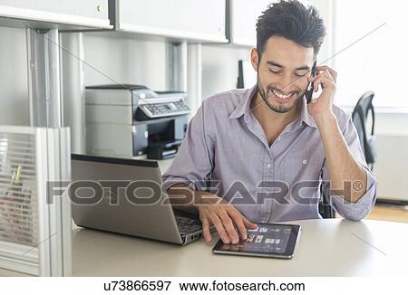 Man using technology in office View Large Photo Image Stock Photo - Man using technology in office. Fotosearch