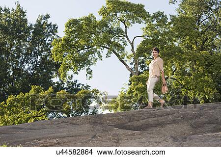 Mature woman walking on rock View Large Photo Image Picture - Mature woman walking on rock. Fotosearch
