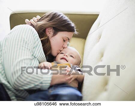Mother and baby boy (6-11 months) lying on sofa View Large Photo Image Stock Photograph - Mother and baby boy (6-11 months) lying on sofa. Fotosearch