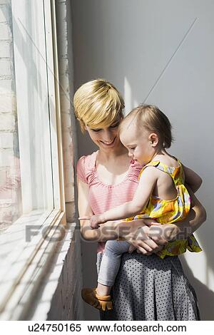 Stock Photography - Mother holding daughter (12-17 months). Fotosearch