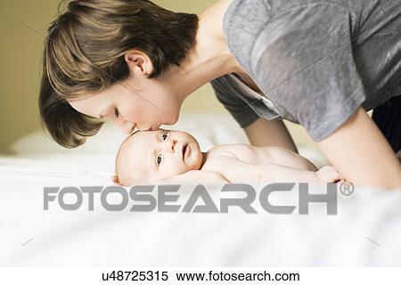 Mother kissing baby boy (2-5 months) View Large Photo Image Stock Photography - Mother kissing baby boy (2-5 months). Fotosearch