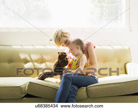 Picture - Mother playing with baby daughter (12-17 months). Fotosearch