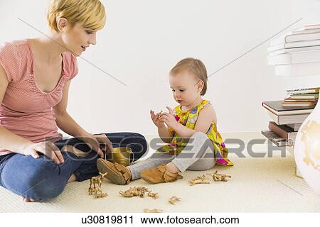 Mother playing with baby daughter (12-17 months) View Large Photo Image Stock Image - Mother playing with baby daughter (12-17 months). Fotosearch