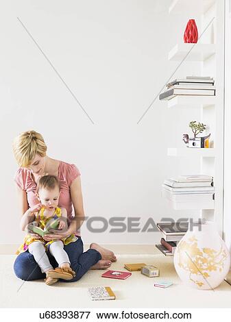 Stock Photo - Mother playing with baby daughter (12-17 months). Fotosearch