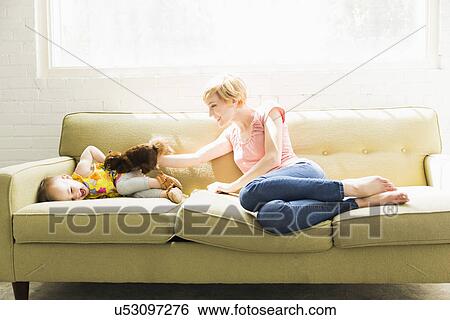 Mother playing with baby daughter (12-17 months) View Large Photo Image Stock Photograph - Mother playing with baby daughter (12-17 months). Fotosearch