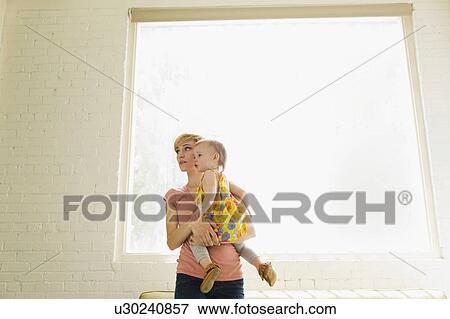 Stock Photo - Mother with baby daughter (12-17 months). Fotosearch