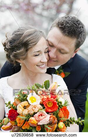 Newly wed couple kissing View Large Photo Image Stock Photo - Newly wed couple kissing. Fotosearch