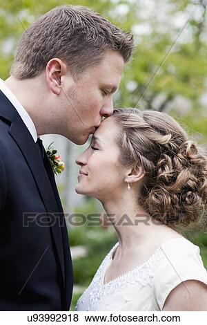 Stock Photo - Newly wed couple kissing. Fotosearch