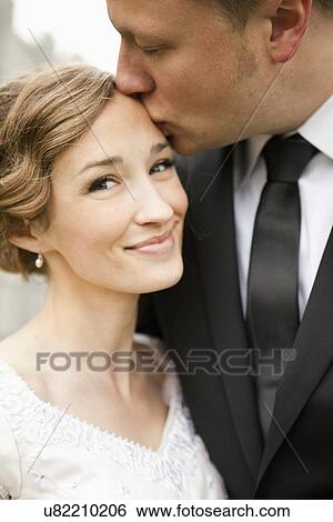 Newly wed couple kissing View Large Photo Image Stock Photograph - Newly wed couple kissing. Fotosearch