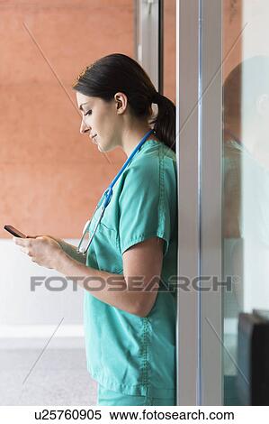 Nurse text messaging View Large Photo Image Stock Photography - Nurse text messaging. Fotosearch