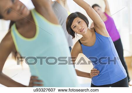 People stretching in gym View Large Photo Image Stock Photo - People stretching in gym. Fotosearch