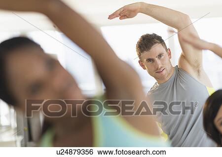 Stock Photograph - People stretching in gym. Fotosearch