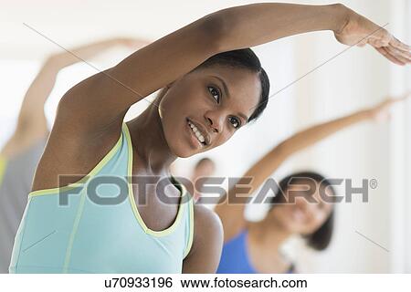 Stock Photograph - People stretching in gym. Fotosearch