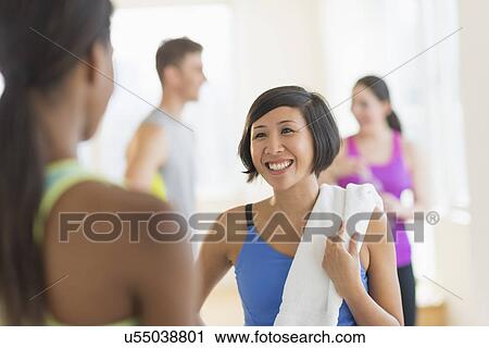 Stock Image - People talking in gym. Fotosearch