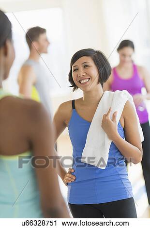 Stock Image - People talking in gym. Fotosearch