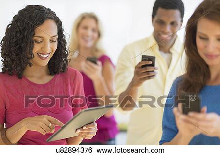 People using communication devices View Large Photo Image Stock Photograph - People using communication devices. Fotosearch