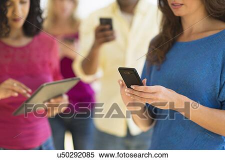 Stock Photography - People using various digital devices. Fotosearch