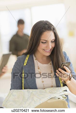 Stock Image - People working in fashion studio. Fotosearch